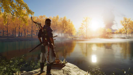 A samurai from Ghost of Tsushima stands by a lakeside at sunrise, surrounded by autumn trees in a 4K Ultra HD PlayStation 5 video game desktop wallpaper.