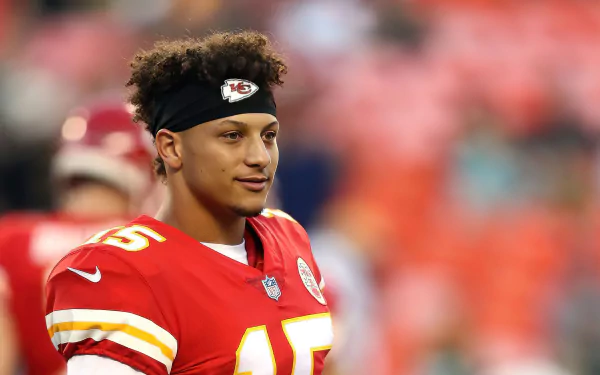 HD wallpaper of an NFL player in a red Kansas City Chiefs jersey, number 15, with a football field in the background.