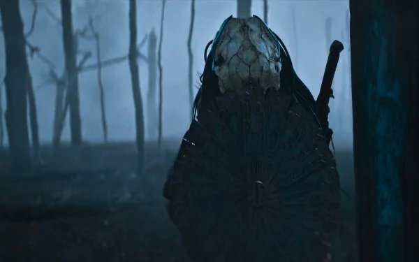 Prey (2022) movie 2K Quad HD PC wallpaper: masked Predator silhouette with circular armor and blade in a foggy forest, bathed in blue-green cinematic light.