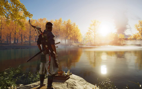 A samurai from Ghost of Tsushima stands by a lakeside at sunrise, surrounded by autumn trees in a 4K Ultra HD PlayStation 5 video game desktop wallpaper.