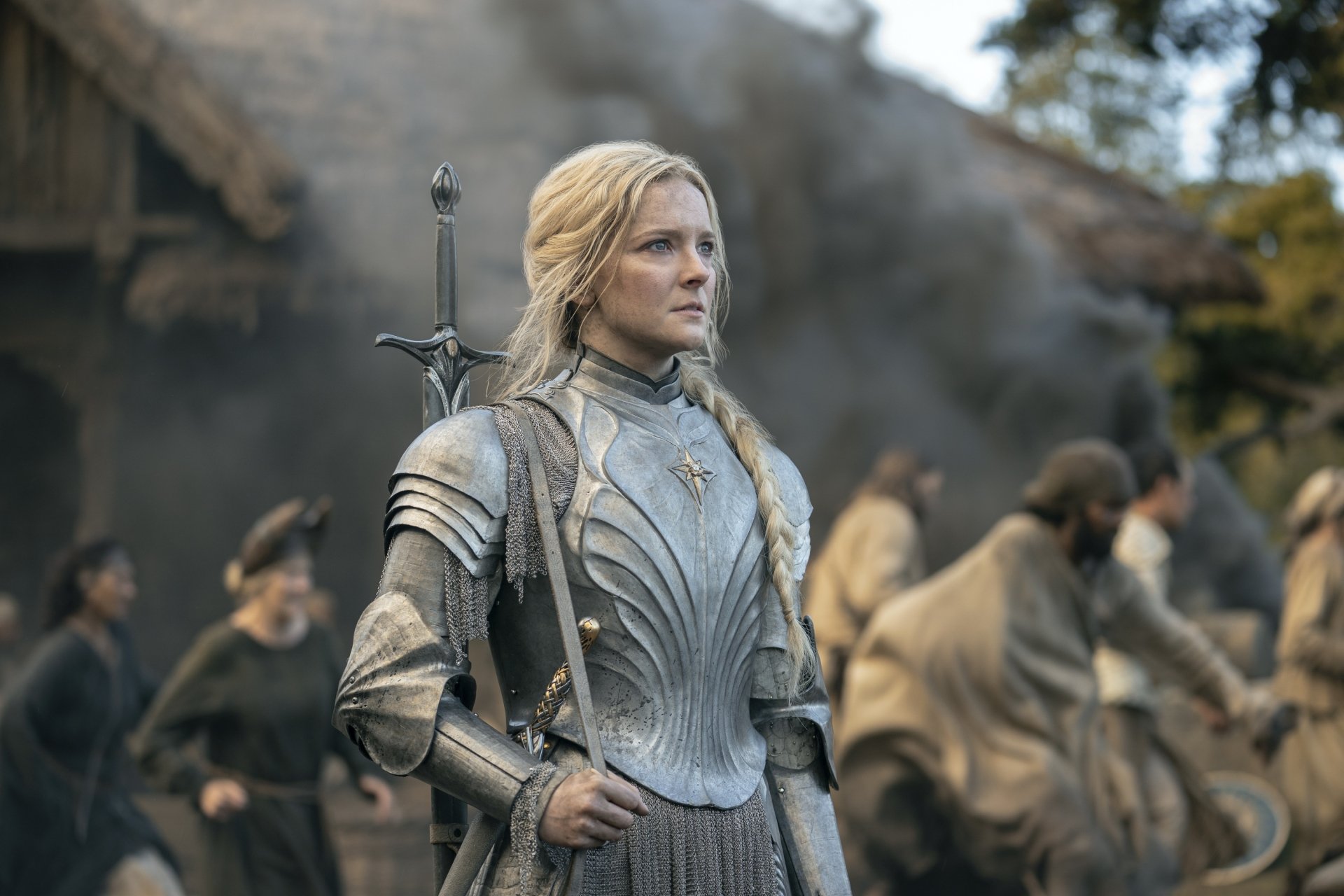 Morfydd Clark as Galadriel in HD desktop wallpaper from the TV show The Lord of the Rings: The Rings of Power, standing in armor with a sword on her back.