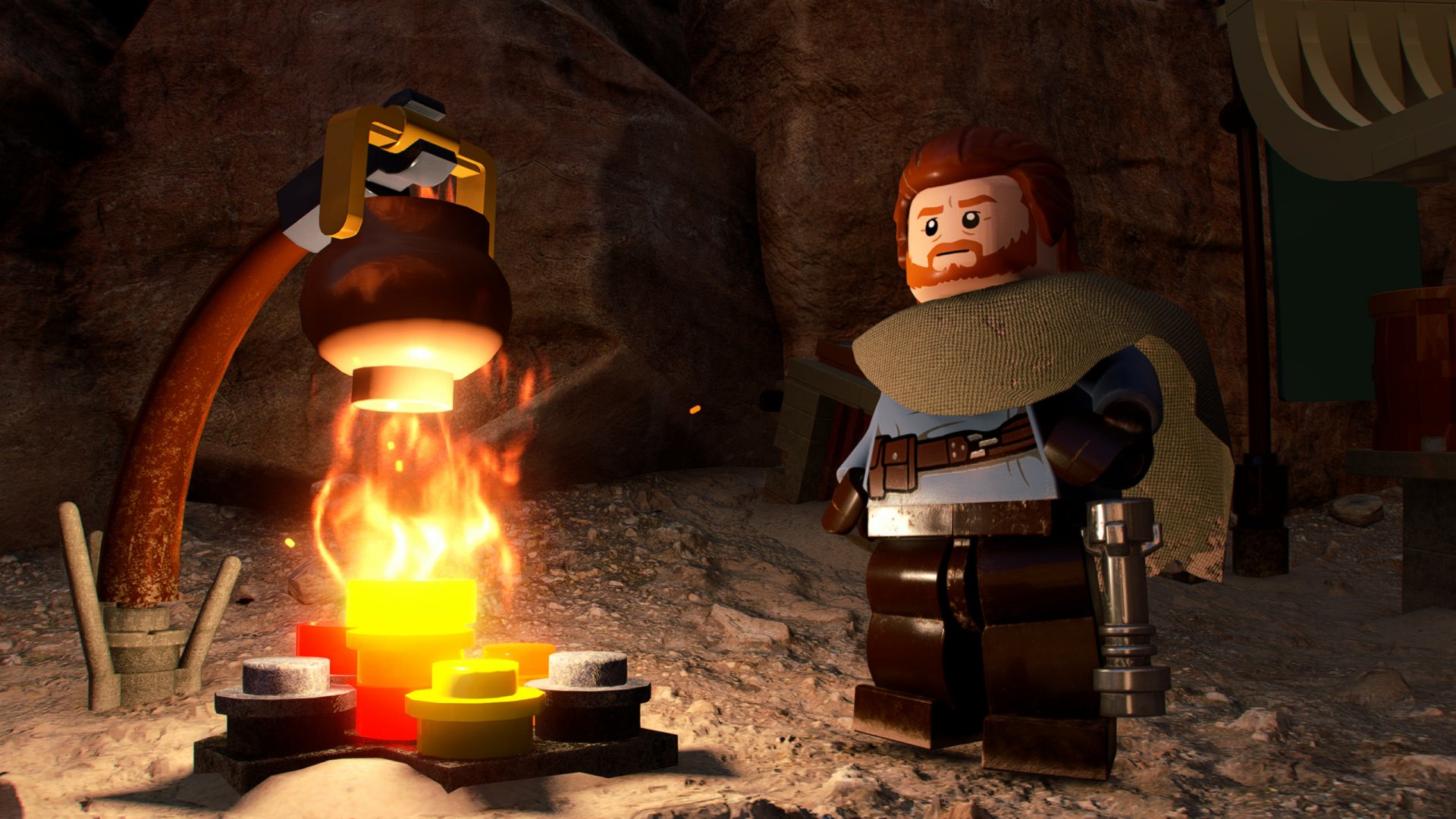 Video game Lego Star Wars: The Skywalker Saga 2K Quad HD PC desktop wallpaper showing a cloaked Lego character warming by a glowing campfire in a rocky cave.