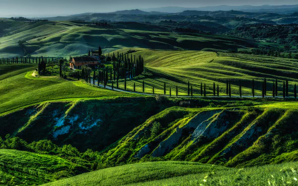 4K Ultra HD photo capturing the rolling green hills and winding cypress-lined roads of Tuscany, Italy, showcasing the region’s iconic landscape and natural beauty.