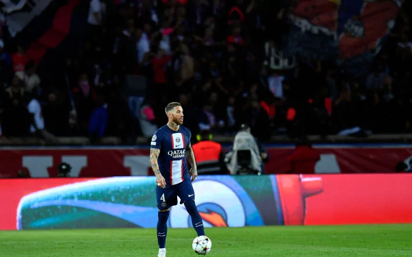 Sergio Ramos in Paris Saint-Germain F.C. kit, striking a powerful pose in vibrant HD desktop wallpaper.