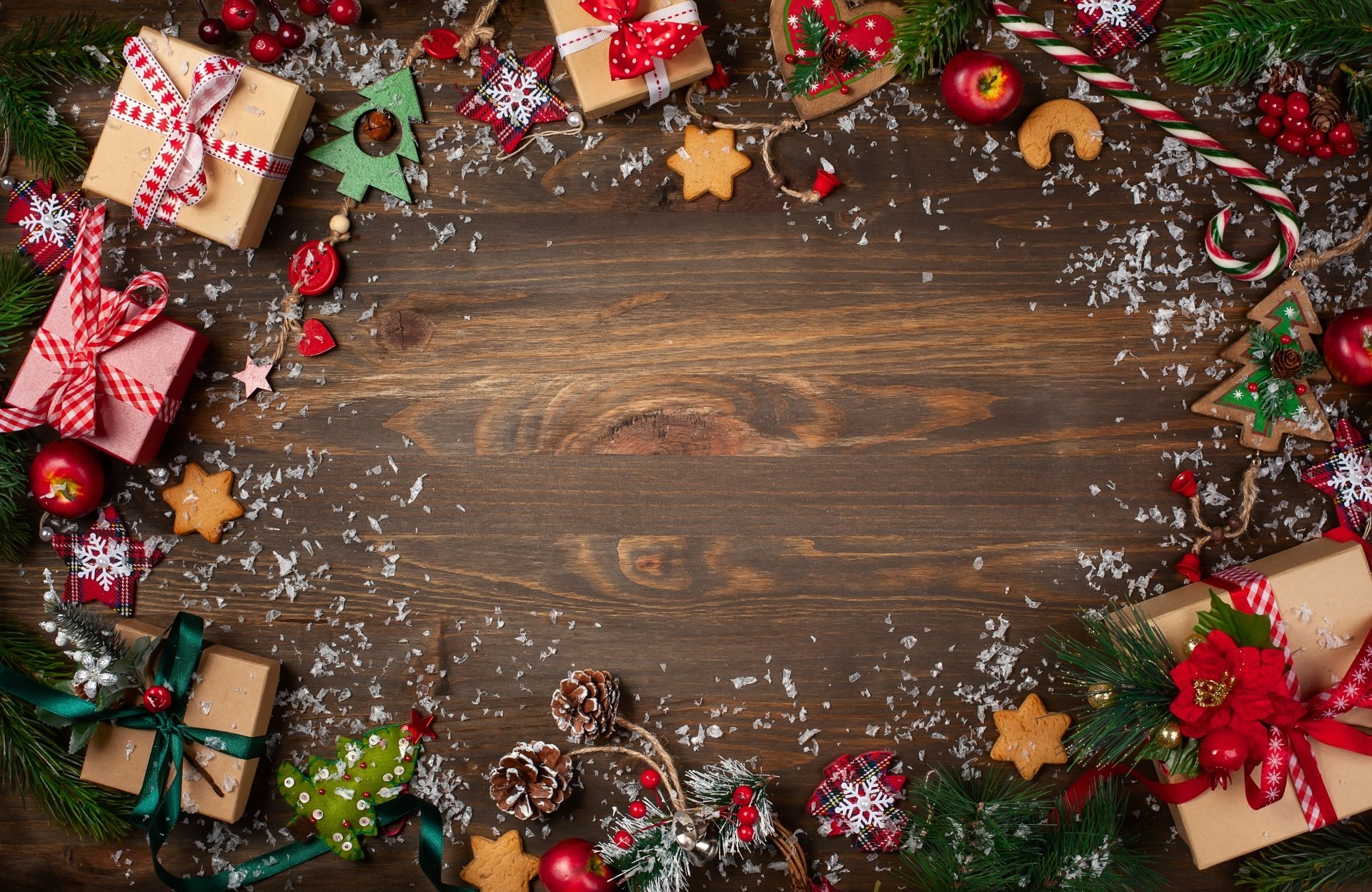 Christmas-themed 4K Ultra HD desktop wallpaper featuring festive gifts, cookies, candy canes, and holiday decorations arranged around a wooden background.