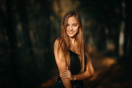 HD desktop wallpaper featuring a smiling woman model with long hair standing outdoors in soft natural light.