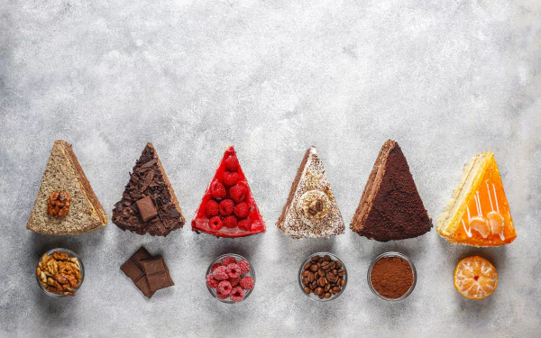 4K Ultra HD desktop wallpaper featuring seven assorted cake slices with matching toppings and ingredients on a light textured background.
