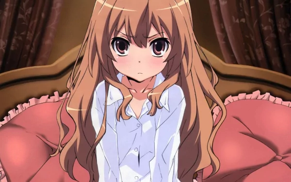 HD wallpaper featuring Taiga Aisaka from the anime Toradora! sitting on a plush pink couch, with a focused expression and her long hair cascading down.