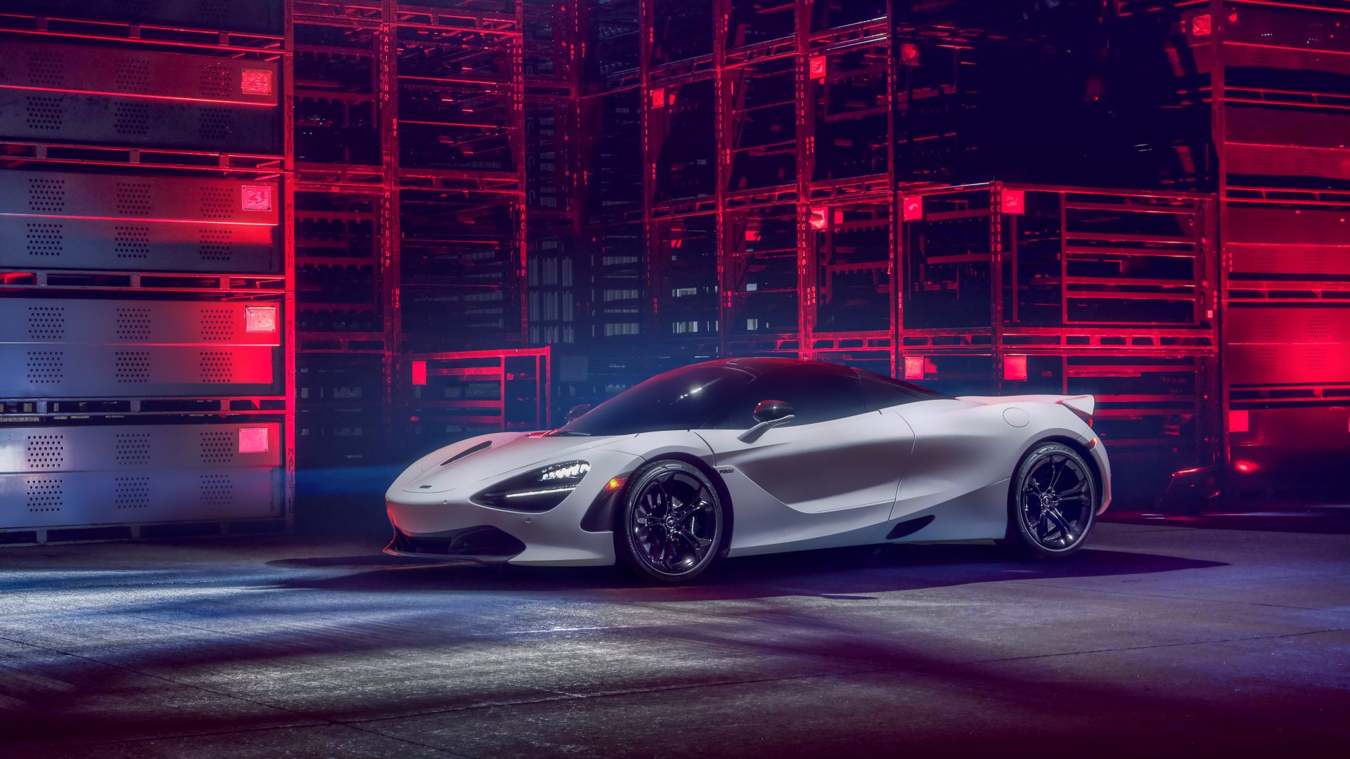 Silver McLaren 720S sports vehicle in a neon-lit industrial garage, 5K Ultra HD PC desktop wallpaper/background.