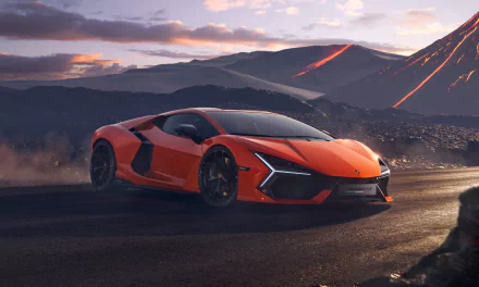 A vibrant orange Lamborghini Revuelto showcased in stunning 4K Ultra HD, set against a dramatic mountainous landscape at sunset.