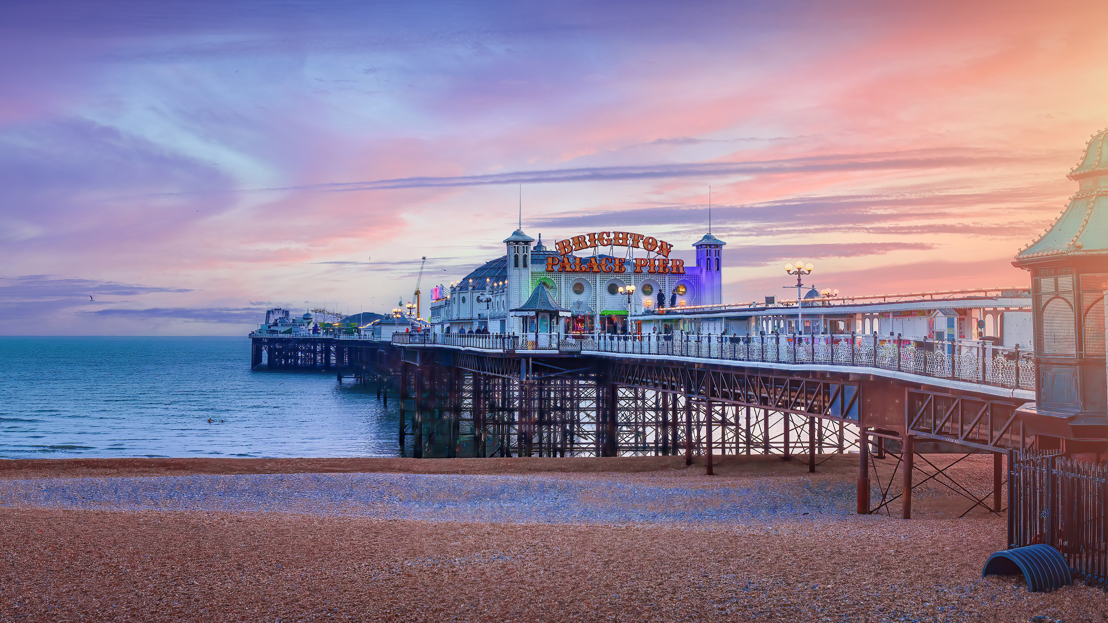 Rides above the tide - Brighton Pier at sunset, England, UK by Peppy Graphics