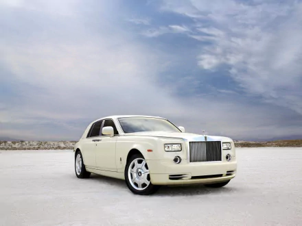 Cream Rolls-Royce Phantom on a vast white salt flat beneath a dramatic cloudy sky — HD PC desktop wallpaper/background of a luxury vehicle.