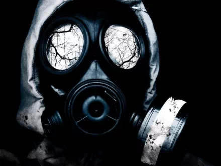 A dark, atmospheric HD desktop wallpaper featuring a gas mask with reflective lenses showcasing bare trees, creating an eerie and thought-provoking visual.
