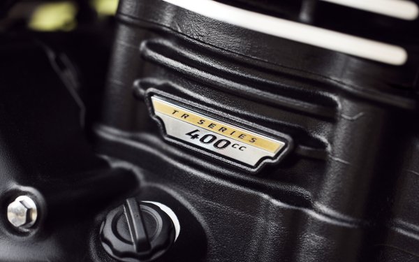 Close-up of the Triumph Scrambler 400 X engine detailing with R series 400cc badge, ideal for a high-definition motorcycle-themed desktop wallpaper or background.