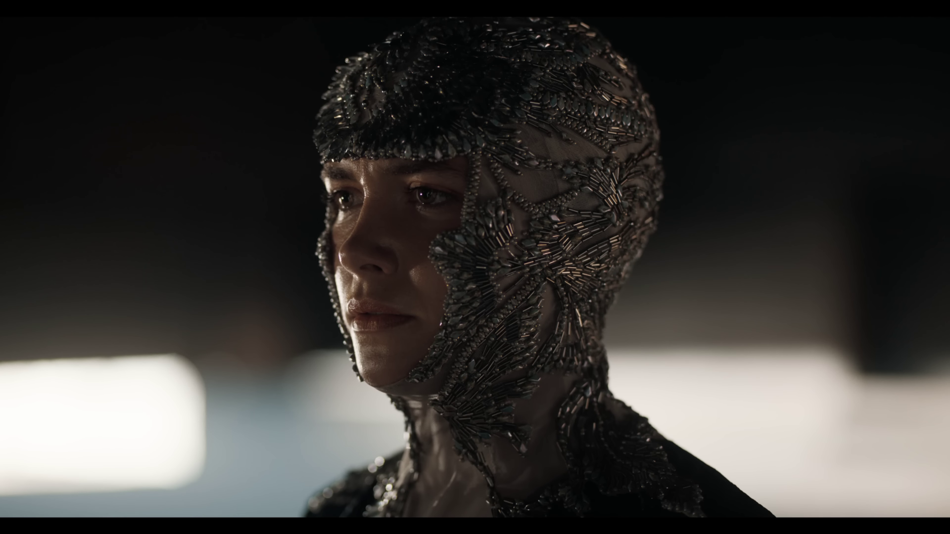 A striking HD desktop wallpaper featuring a character from Dune: Part Two, showcasing intricate details of their metallic costume and an intense expression.