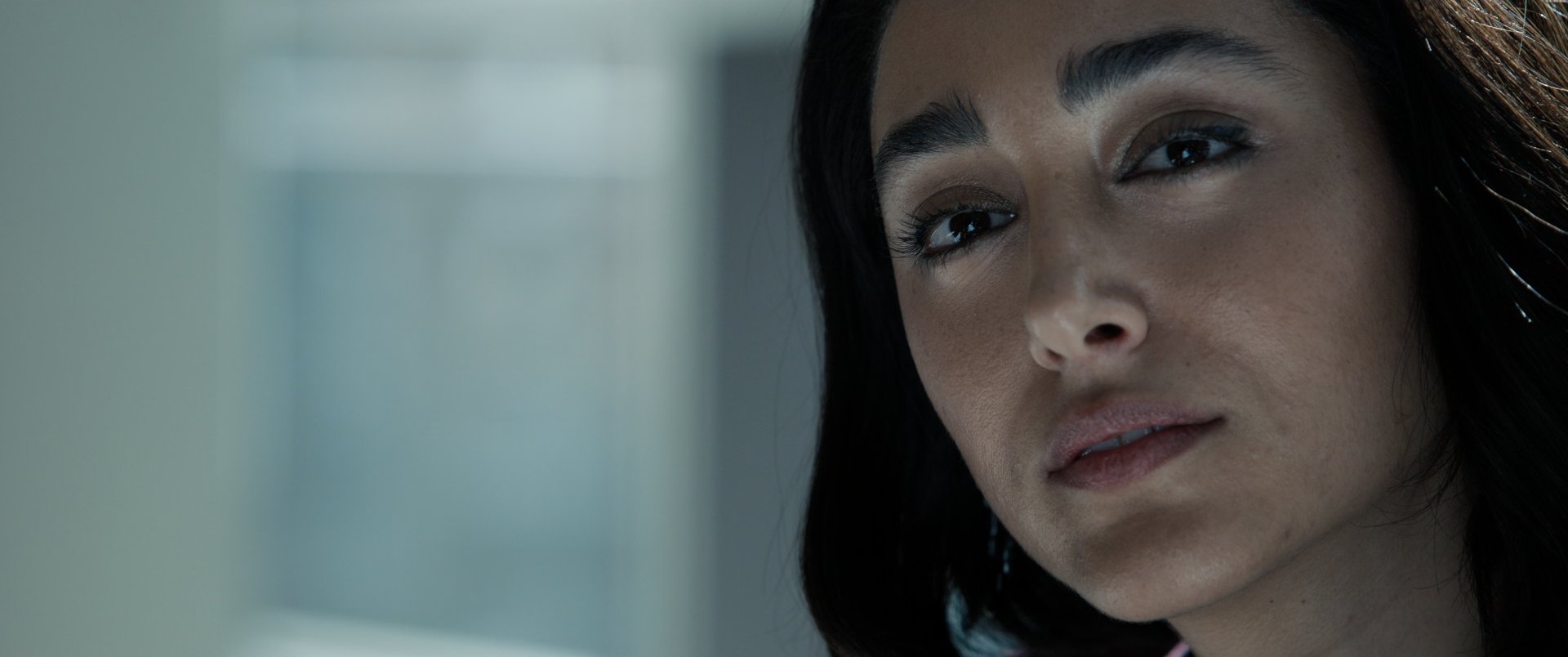 Close-up of a woman's face with a thoughtful expression, possibly from a scene in Extraction 2, suitable as an HD desktop wallpaper and background featuring Golshifteh Farahani.