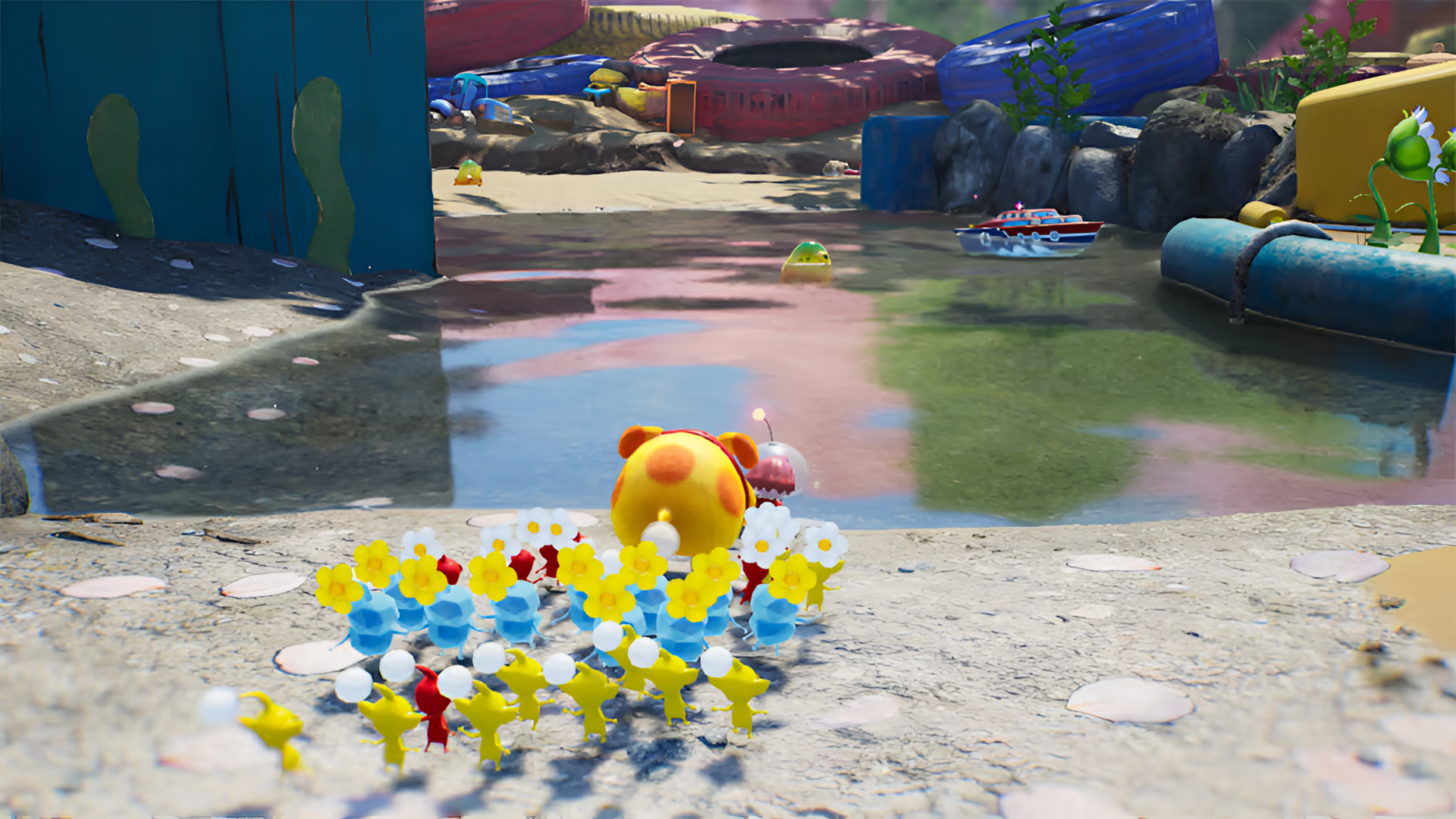 HD desktop wallpaper from Pikmin 4 featuring a group of colorful Pikmin characters in a vibrant outdoor setting with reflective water.