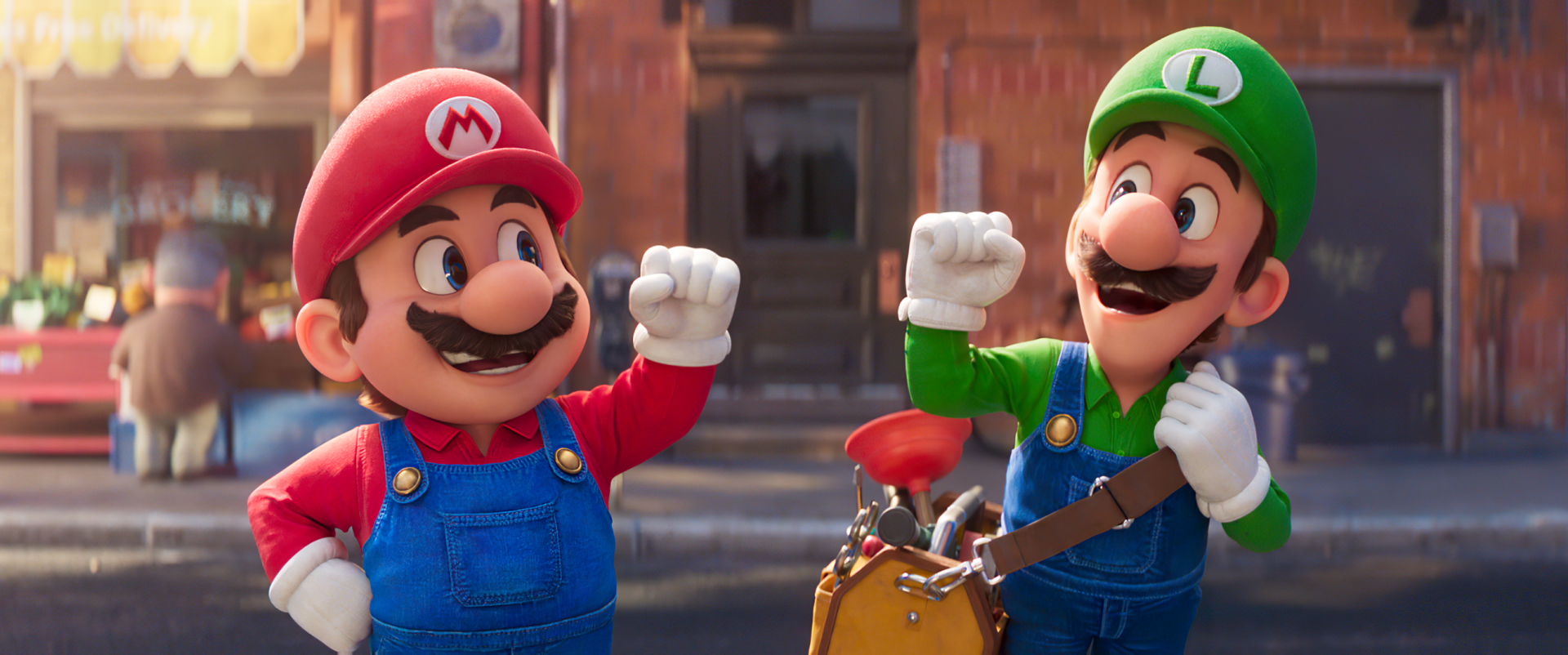 HD desktop wallpaper from the 2023 Super Mario Bros. movie featuring animated characters Mario and Luigi in a lively pose on a city street background.