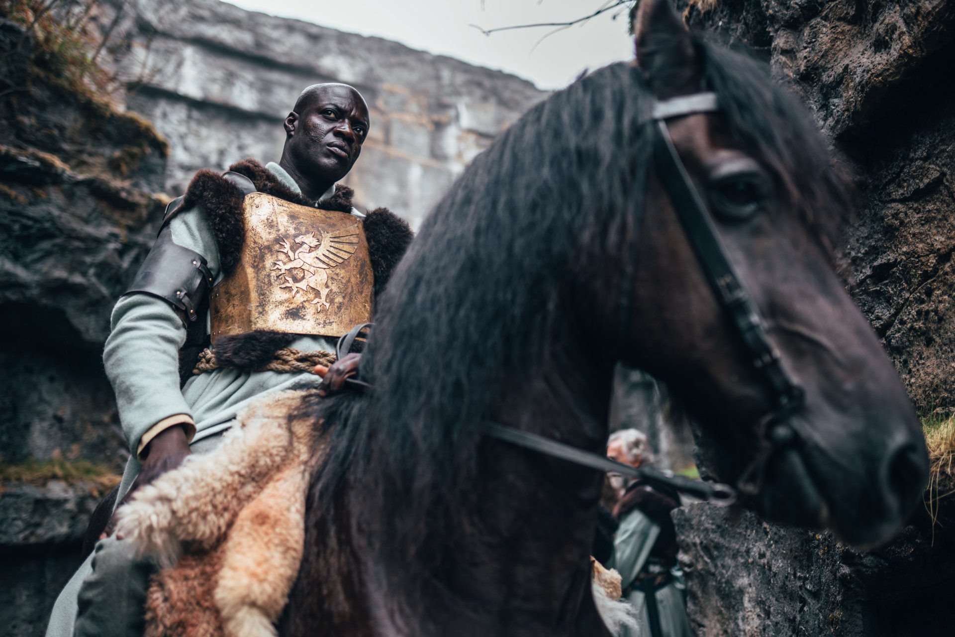 A regal warrior on horseback embodies 'The Winter King,' featured in a HD desktop wallpaper with a dramatic, rocky backdrop.