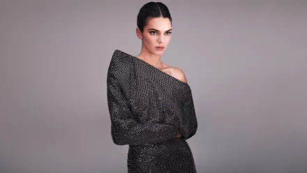 Kendall Jenner poses confidently in a textured, off-shoulder outfit against a neutral background in this 4K Ultra HD PC desktop wallpaper.