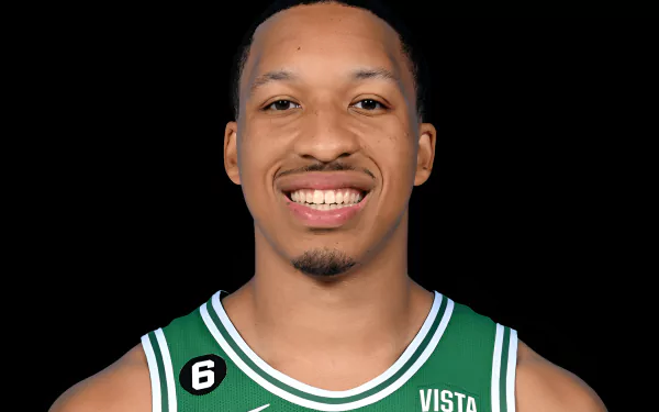 HD desktop wallpaper featuring Grant Williams in a green basketball jersey, smiling against a black background.