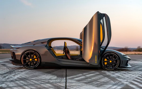 A stunning Koenigsegg Gemera with its distinctive doors open, showcased against a serene sunset backdrop. This HD wallpaper captures the car's sleek design and dynamic presence.