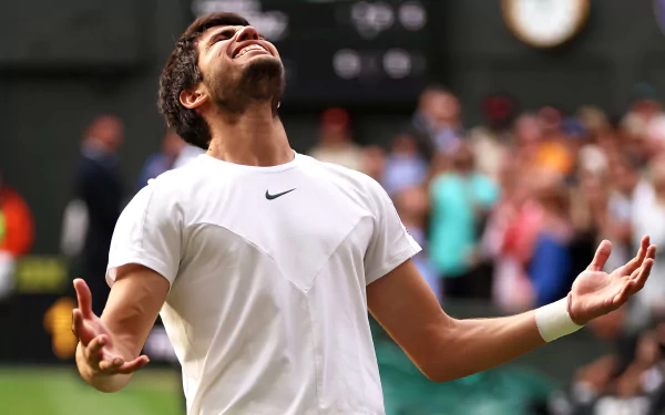 HD desktop wallpaper of tennis player Carlos Alcaraz celebrating a victory at Wimbledon 2023.