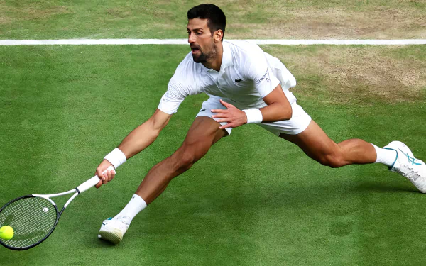 HD Wallpaper of a prominent tennis player stretching for a shot at Wimbledon 2023
