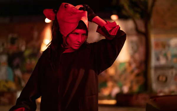 HD wallpaper featuring a scene with Amanda Young character in Saw X, portrayed by an actress in a dark setting with dramatic lighting.