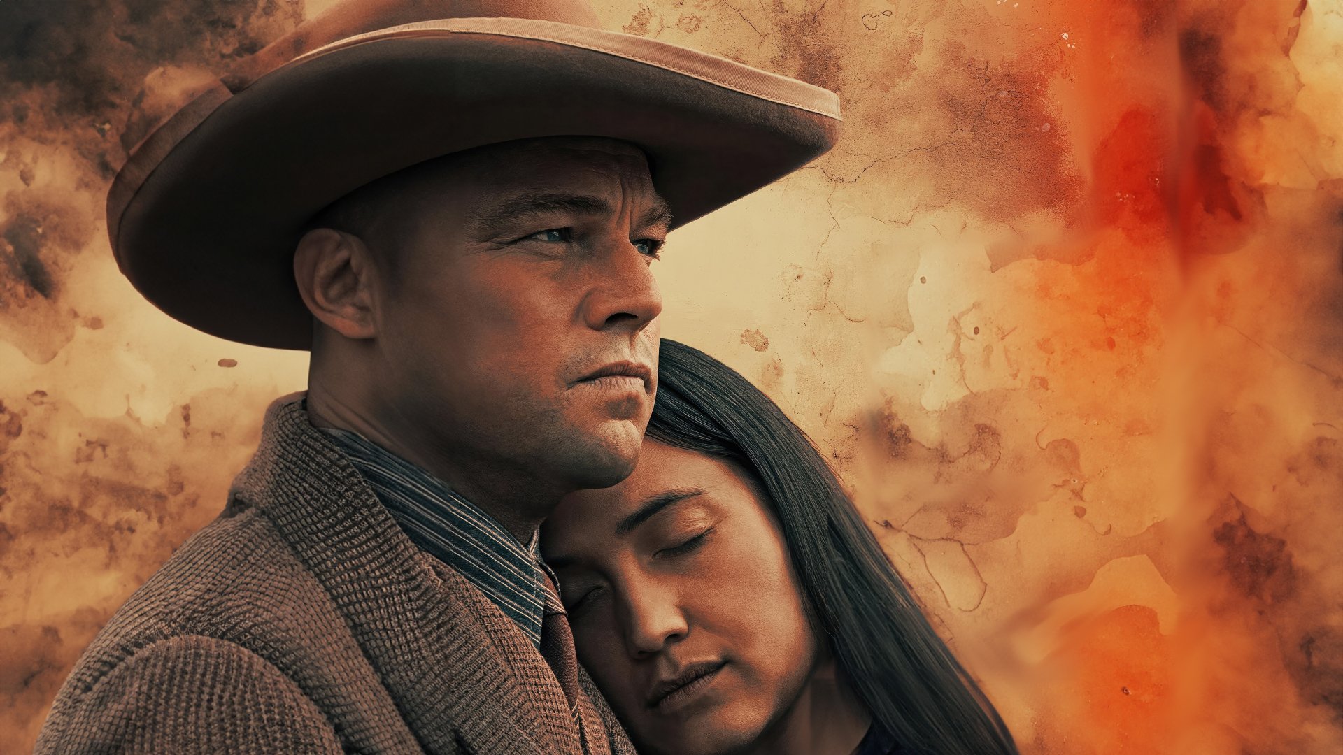 HD desktop wallpaper featuring characters from Killers of the Flower Moon, with a contemplative man in a hat alongside a woman resting her head on his shoulder, set against a fiery, abstract background.