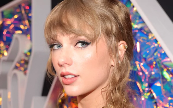 HD desktop wallpaper featuring Taylor Swift, showcasing her unique style and iconic presence in the music scene, complemented by a colorful backdrop.
