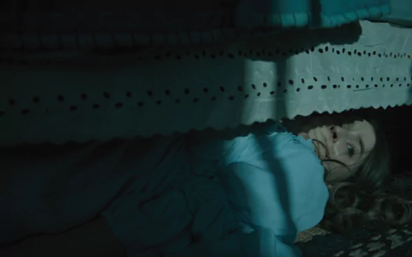 Eerie HD wallpaper featuring a person lying under the bed with a fearful expression, tagged with No One Will Save You, suitable as a suspenseful desktop background.