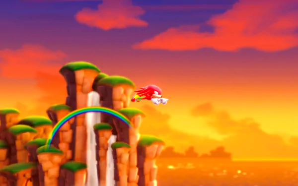 A vibrant HD wallpaper from Sonic Superstars, featuring Knuckles soaring past a waterfall and a rainbow against a stunning sunset backdrop.