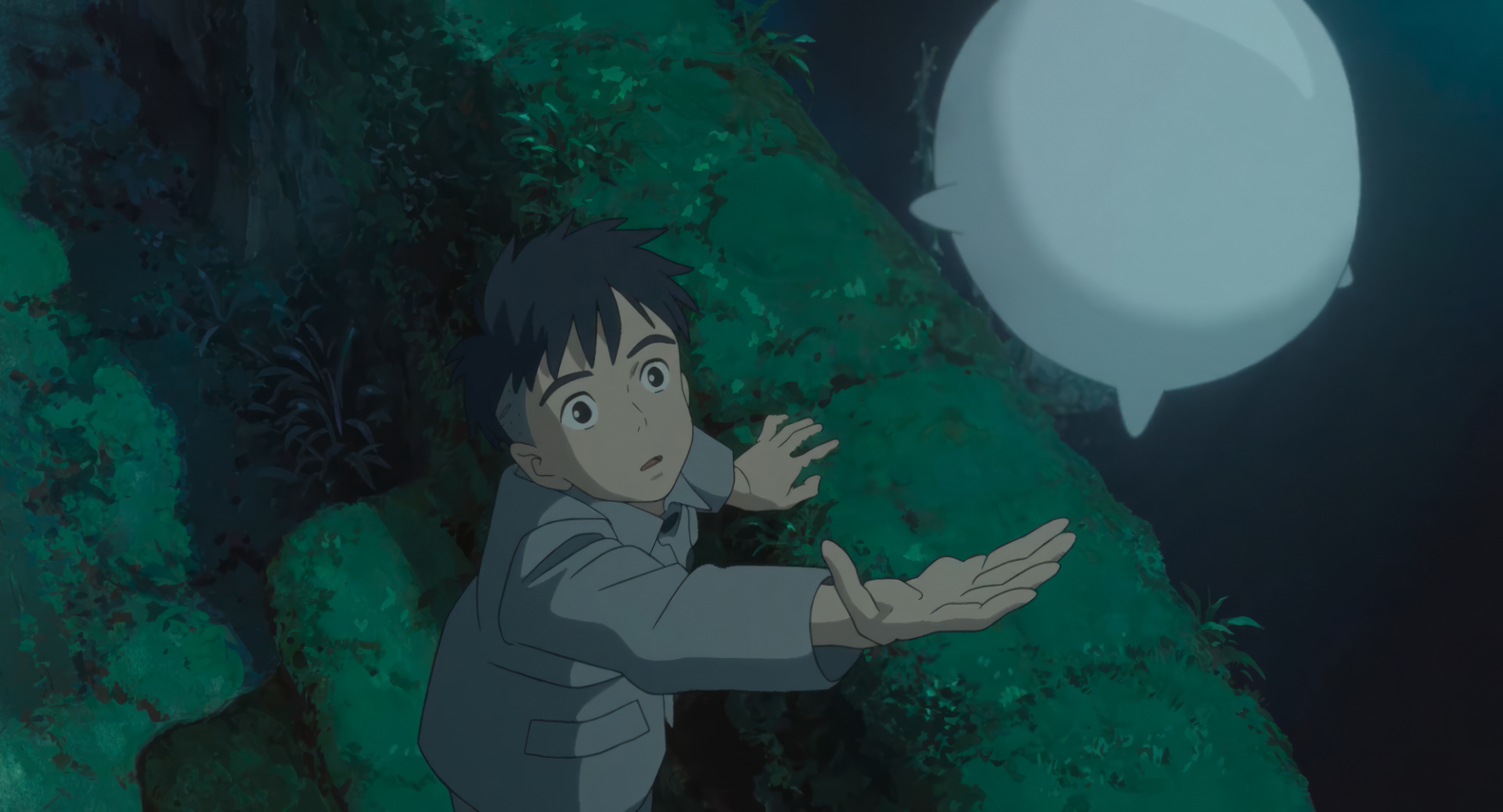 HD desktop wallpaper of The Boy and the Heron featuring a surprised animated boy with an illuminated orb against a dark, mystical backdrop.