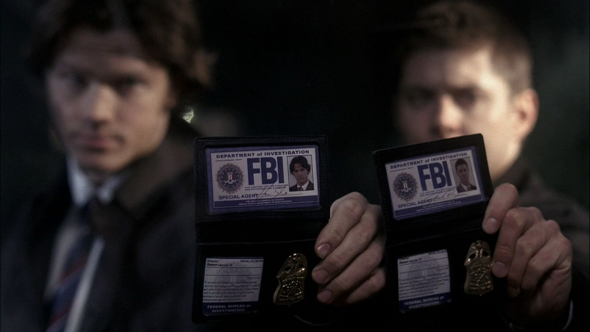 Jared Padalecki and Jensen Ackles from the TV show Supernatural hold FBI badges in this HD PC desktop wallpaper and background.