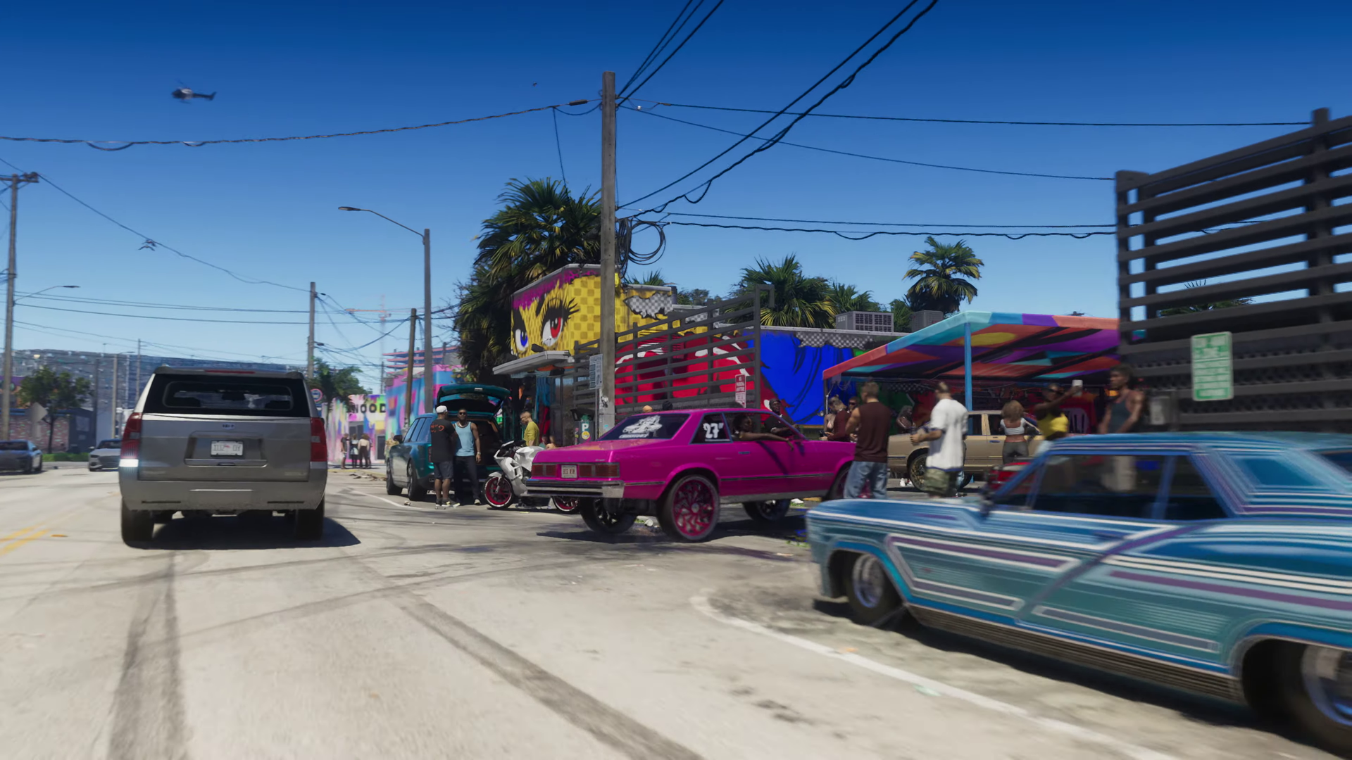 4K Ultra HD desktop wallpaper showcasing a vibrant street scene from the video game Grand Theft Auto VI, featuring colorful cars and market stalls under a clear blue sky.