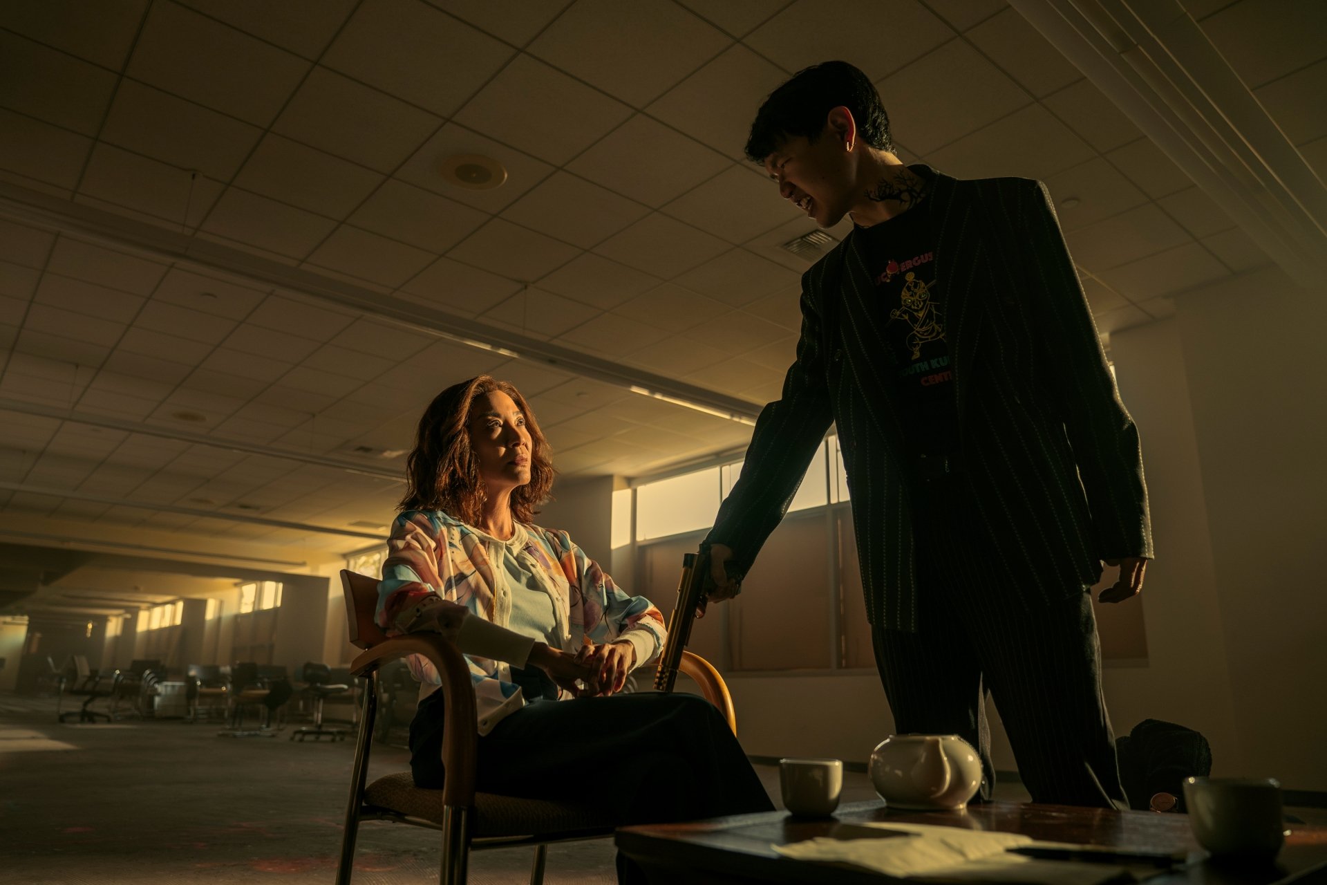 HD wallpaper featuring a dramatic scene from the TV show The Brothers Sun, with two characters in a dimly lit room.