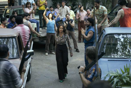 HD desktop wallpaper from the TV show Griselda (2024), featuring a tense street scene with a central character standing confidently.