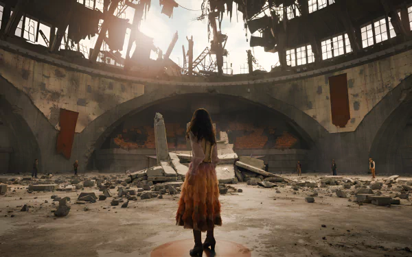 HD wallpaper of a scene from The Hunger Games: The Ballad of Songbirds & Snakes featuring a character standing amidst the ruins of an arena.