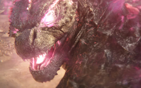An intense close-up of Godzilla from Godzilla x Kong: The New Empire, showcasing its powerful presence with glowing eyes and fierce expression. High-definition wallpaper for fans.