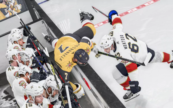 Hockey action from video game NHL 24 captured in HD desktop wallpaper featuring players by the rink boards.