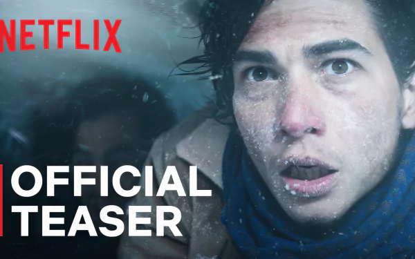 HD wallpaper of Society of the Snow movie with Official Teaser text, featuring a man in snowy conditions, available on Netflix.
