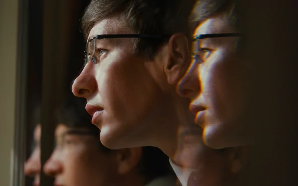 HD desktop wallpaper featuring a profile view of a person with a reflective effect creating multiple overlapping images, tagged with the movie 'Saltburn (2023)' for background use.