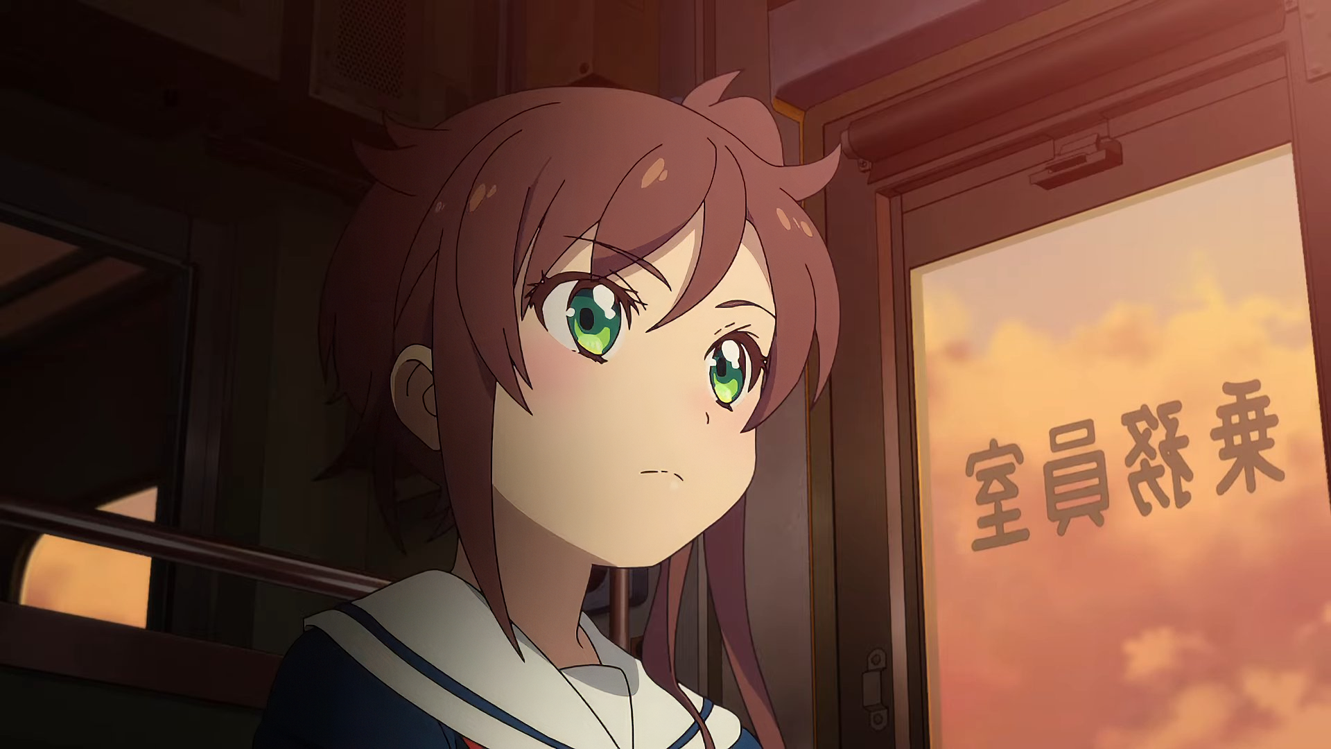 An anime character with green eyes and brown hair gazes thoughtfully from a train window, featured in Train to the End of the World. A captivating HD desktop wallpaper.