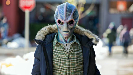 HD desktop wallpaper featuring alien character from the TV Show Resident Alien walking on a city street.