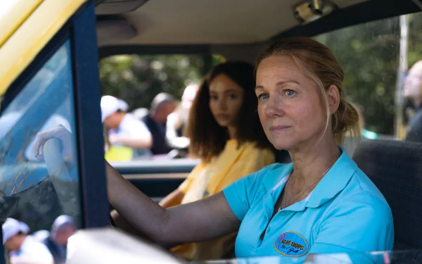 HD wallpaper of a scene from the 2024 movie Suncoast featuring a woman driving with a passenger in the background.