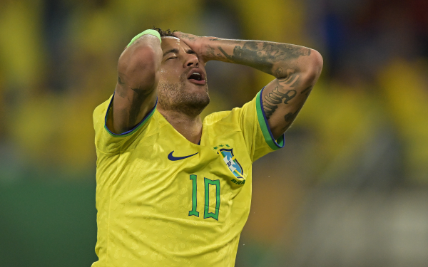 Soccer player in Brazil National Team jersey expressing emotion on the field, perfect as an HD desktop wallpaper for soccer fans.