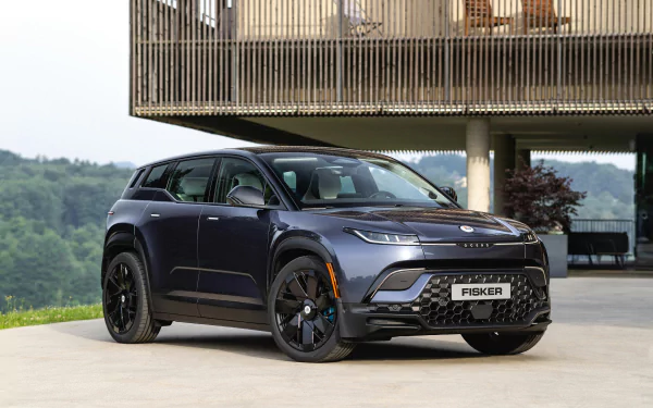 Fisker Ocean electric car displayed as an HD desktop wallpaper with a modern house in the background.