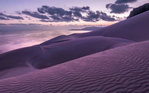 HD wallpaper of a serene sand dune landscape under a twilight sky, perfect as a calming desktop background.