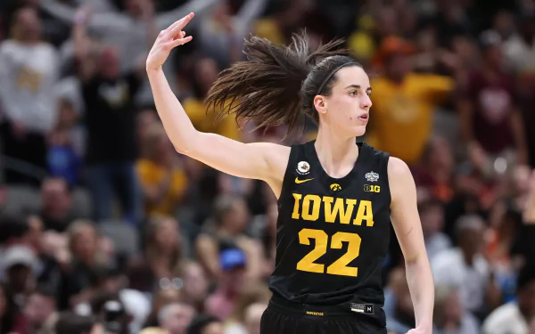 HD desktop wallpaper featuring basketball player Caitlin Clark in an Iowa jersey mid-action on the court.